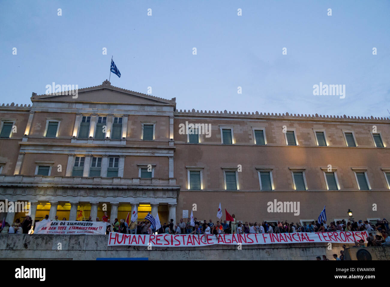 Athens, Greece. 21st June, 2015. An anti-austerity placard hangs in front of the Parliament building. Greeks demonstrate against austerity prior to Monday's 22nd July Eurogroup which is possible to decide if Greece remains or exits Eurozone. Credit:  Kostas Pikoulas/Pacific Press/Alamy Live News Stock Photo