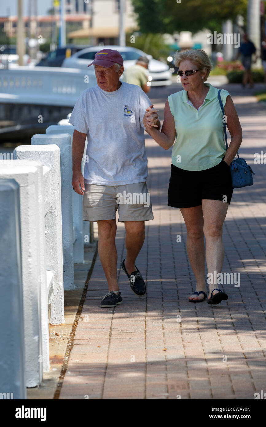 Senior couple in summer clothing walking hand in hand Stock Photo
