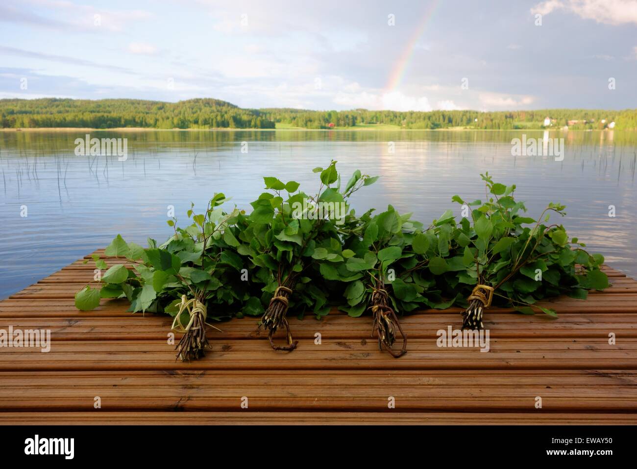 Traditional Finnish sauna whisks on a jetty by the lake Stock Photo