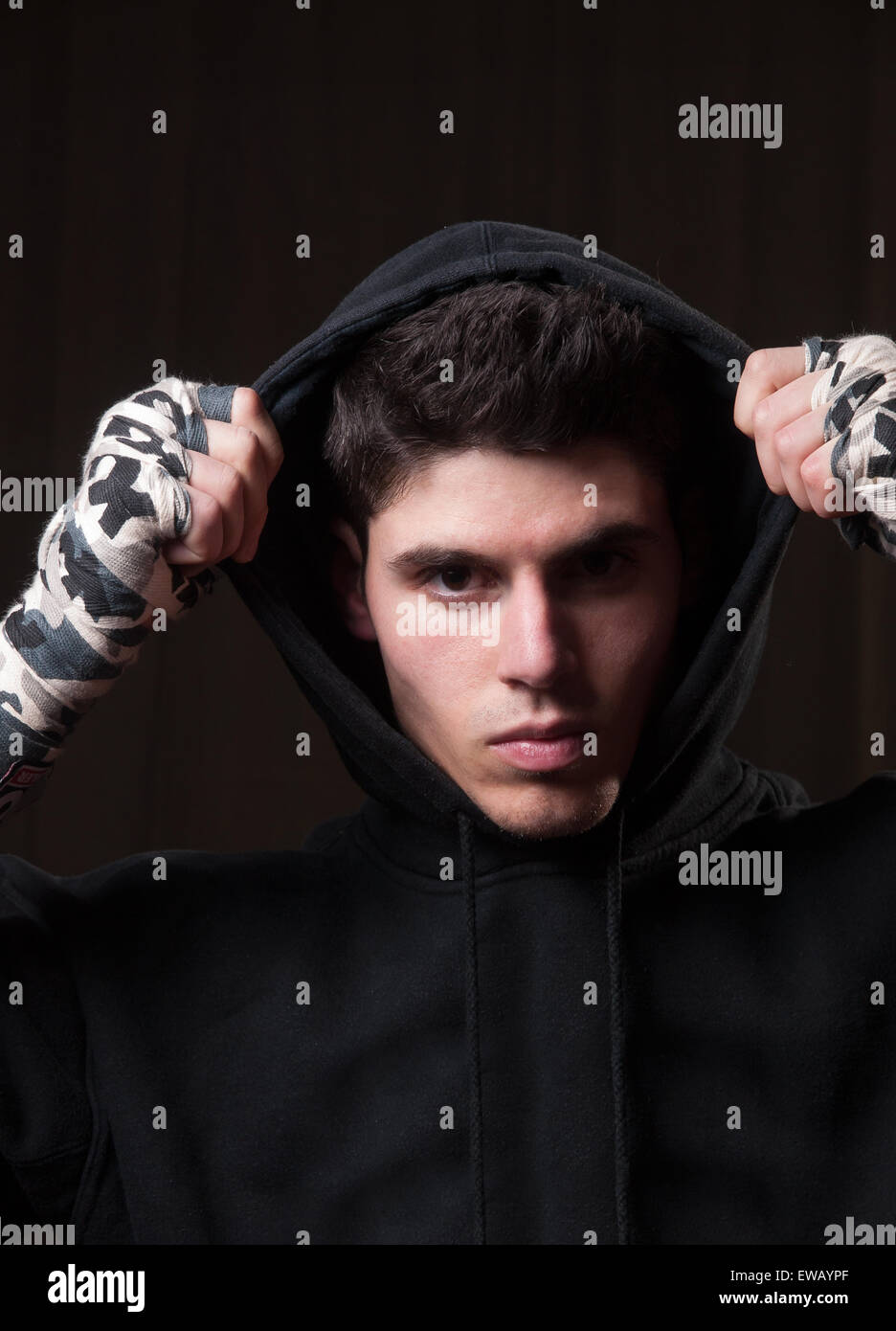 Boxer man with hoodie over dark background in a studio shot. Stock Photo