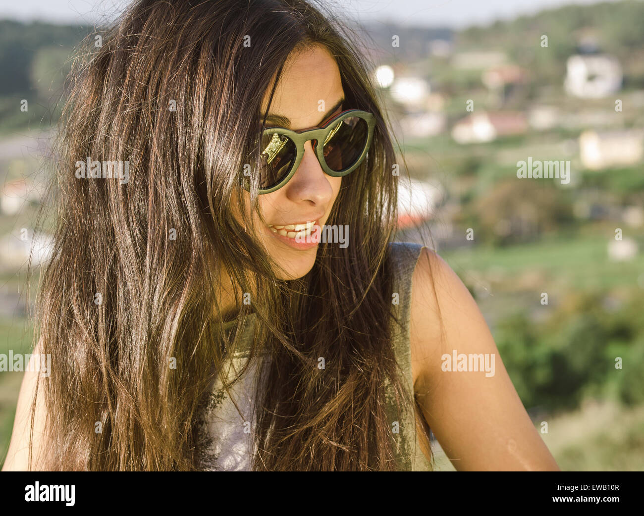 Woman with sunglasses in a portrait outdoors. Stock Photo