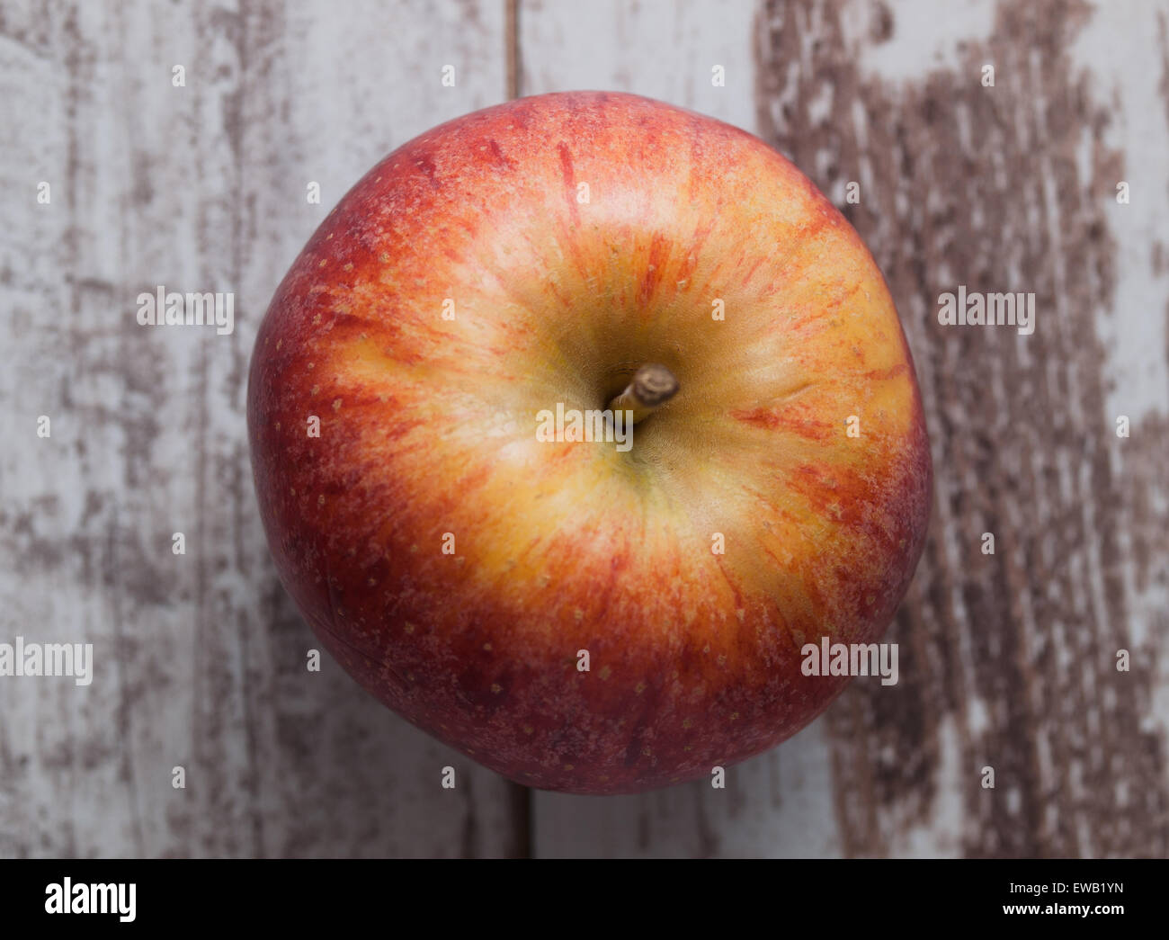 One red apple overhead over wooden background Stock Photo