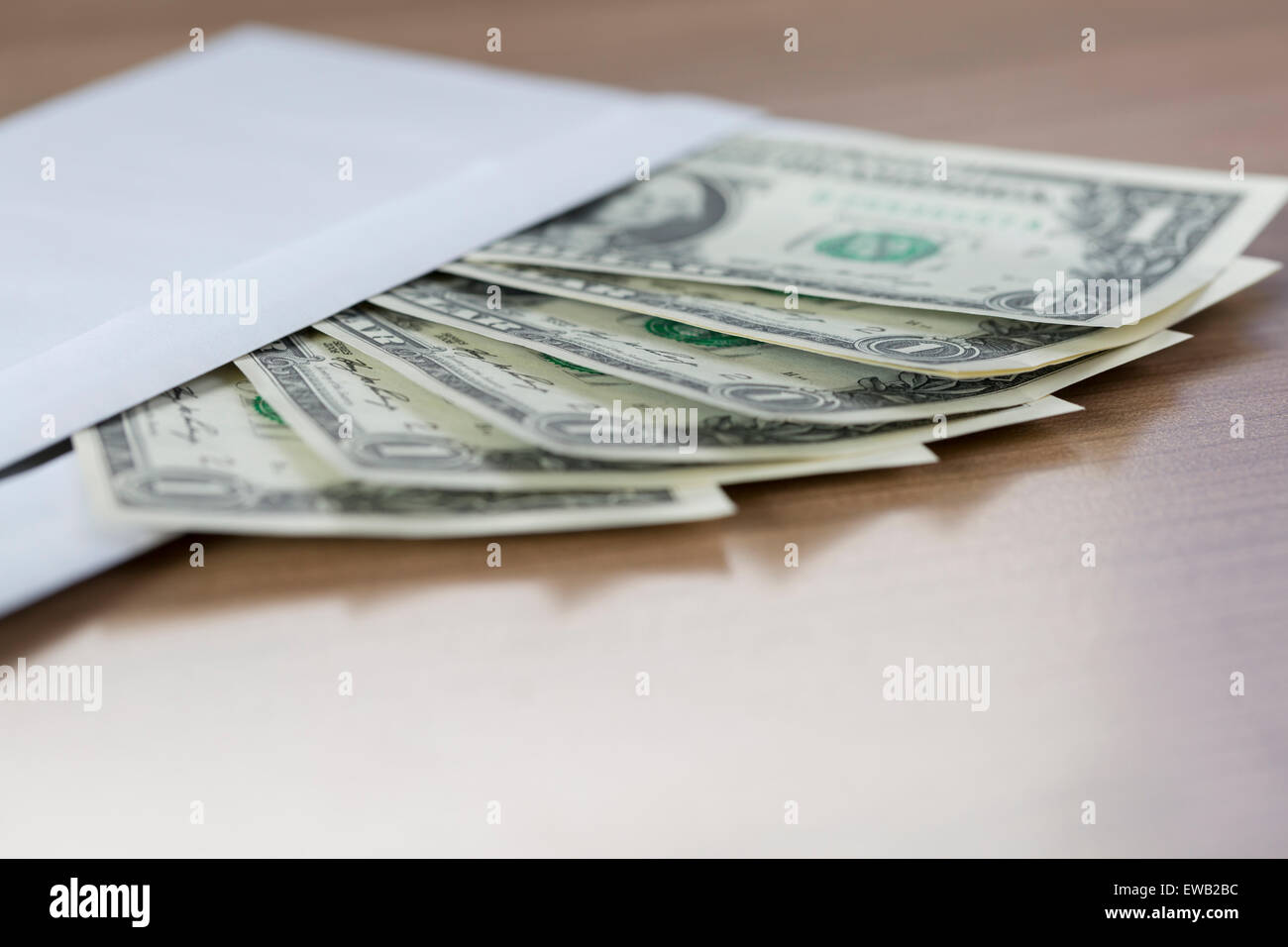 closeup of Dollar Notes in an envelope on a wooden table Stock Photo