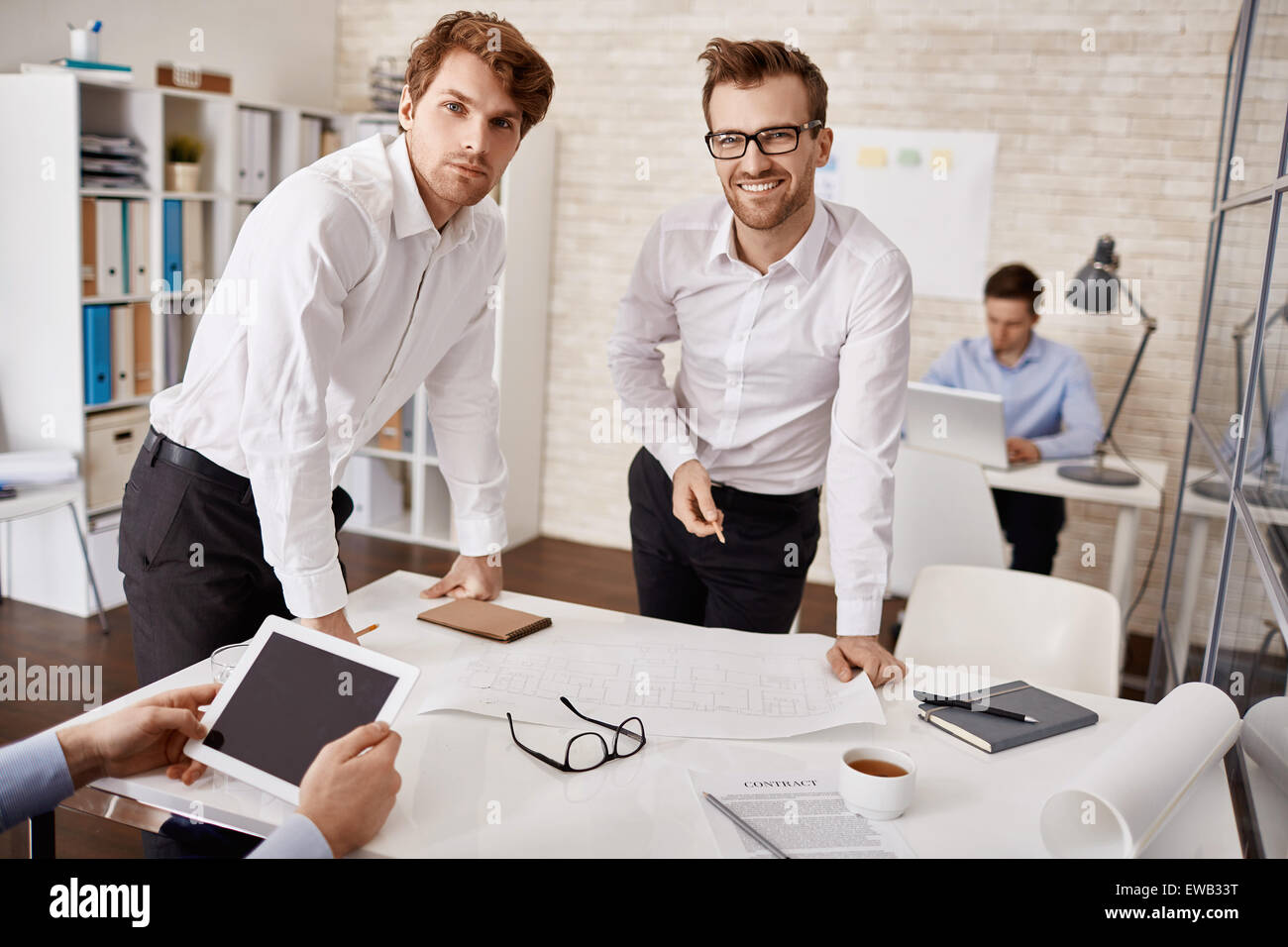 Elegant young architects looking at camera in working environment Stock ...