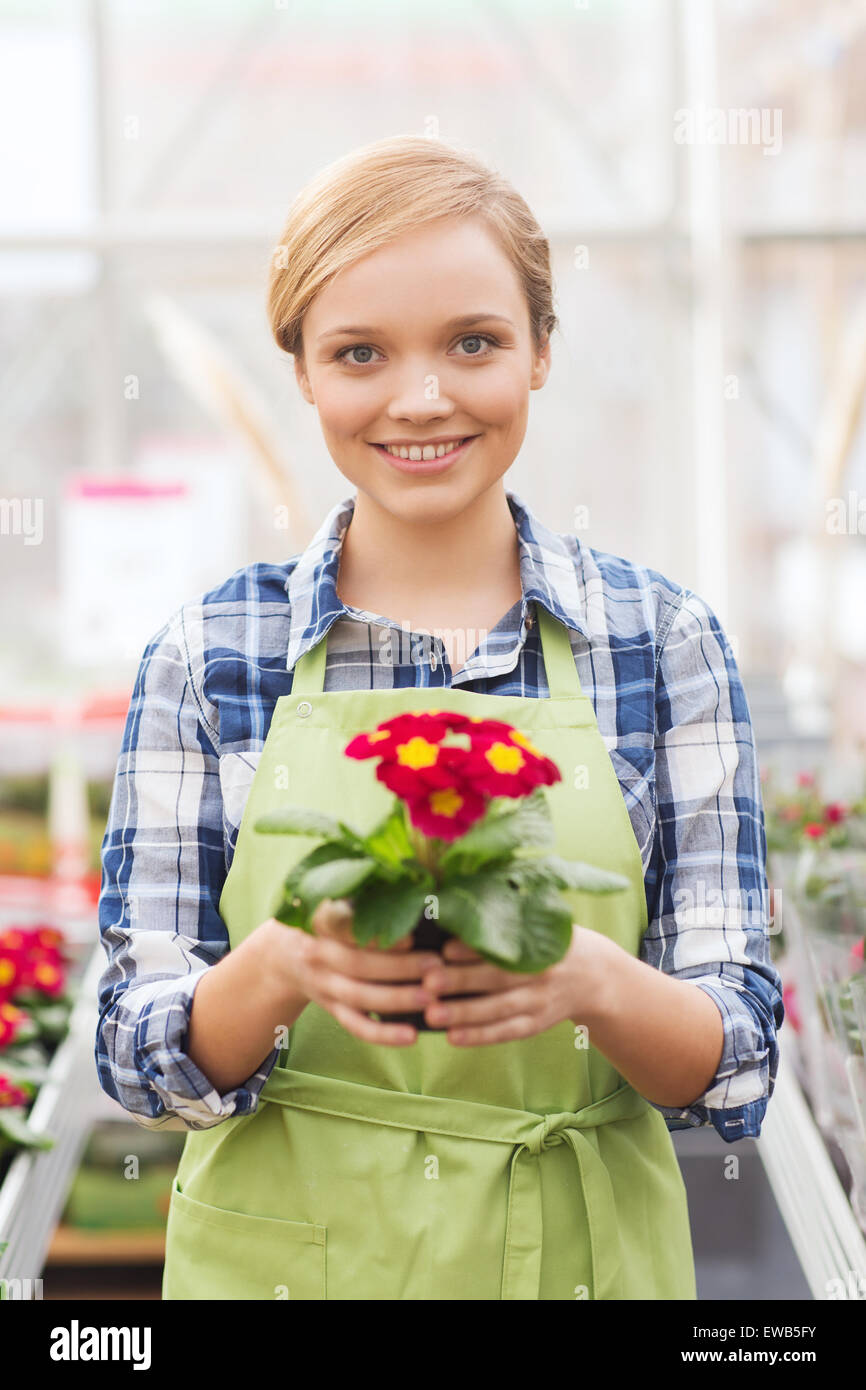 happy woman holding flowers in greenhouse Stock Photo - Alamy