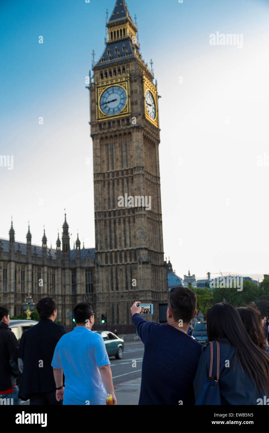 Tourists taking a selfie picture of Big Ben from Westminster Bridge London England UK Stock Photo