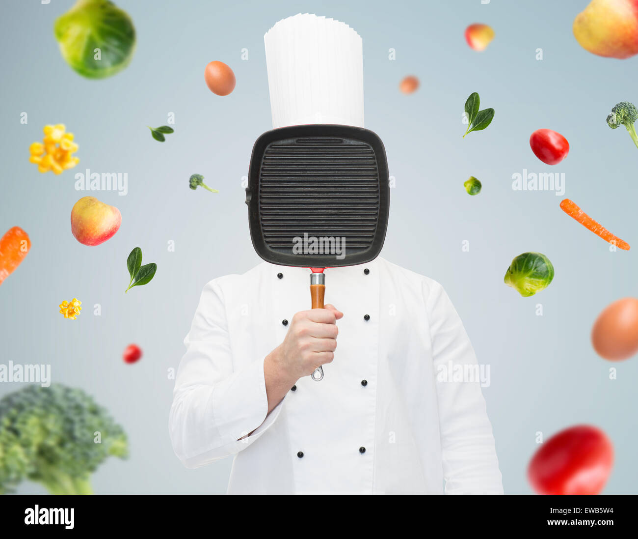 male chef cook covering face with grill pan Stock Photo Alamy