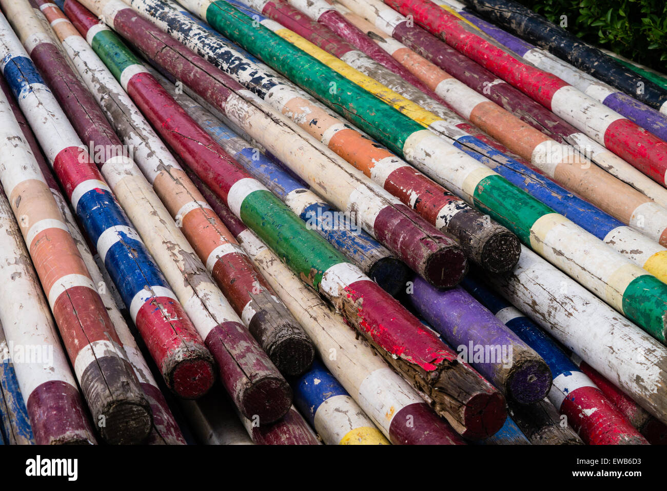 Stack of colourful, striped poles viewed from the right end Stock Photo