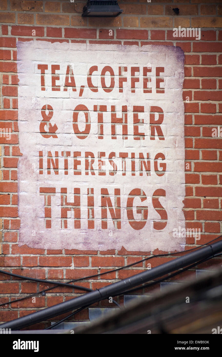 Tea coffee & other interesting things sign on side of brick building at Brewery Square
