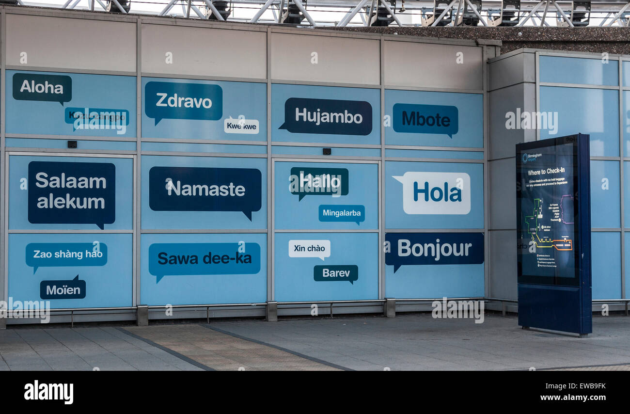 Artwork welcoming people to Birmingham Airport UK with hello in different languages. Where to check in sign. Arrivals terminal. Stock Photo