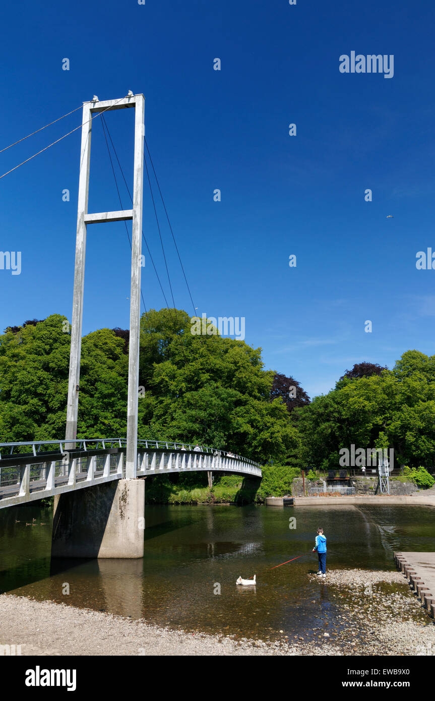Boy with dog and suspension bridge, Blackweir and River Taff, Pontcanna Fields, Cardiff, Wales