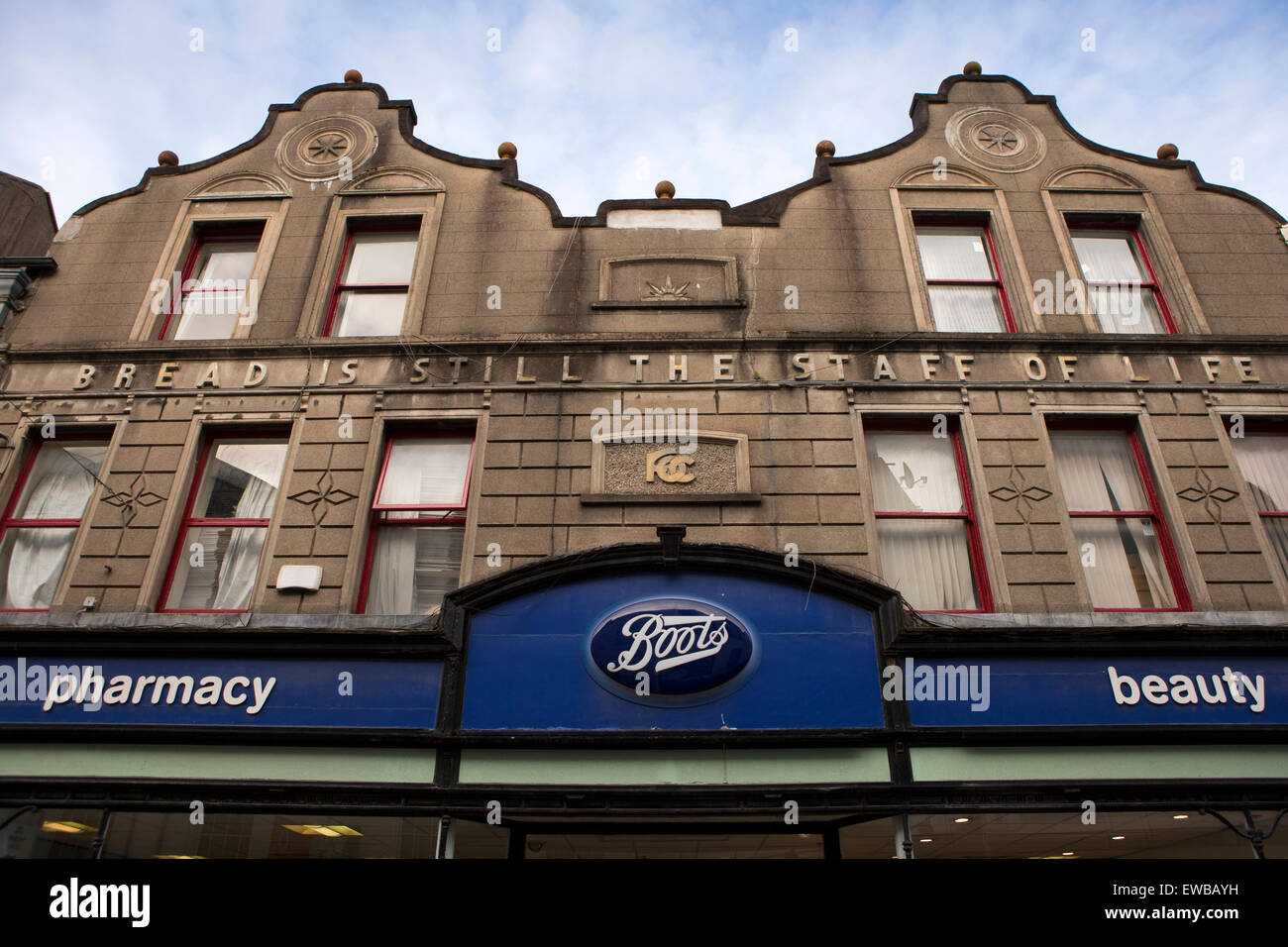 Ireland, Co Wexford,  Town, Main Street South, bread is still the staff of life sign above boots pharmacy entrance Stock Photo