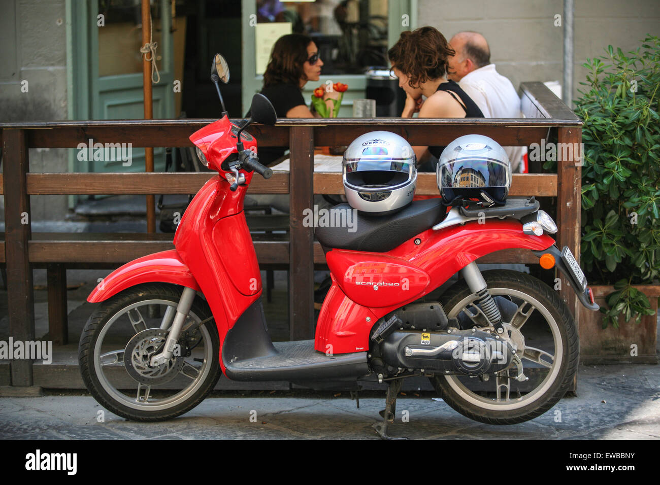 Scooter parked while the owners have a meal at this cafe just south of River Arno in typical local area in central Firenze/ Flor Stock Photo