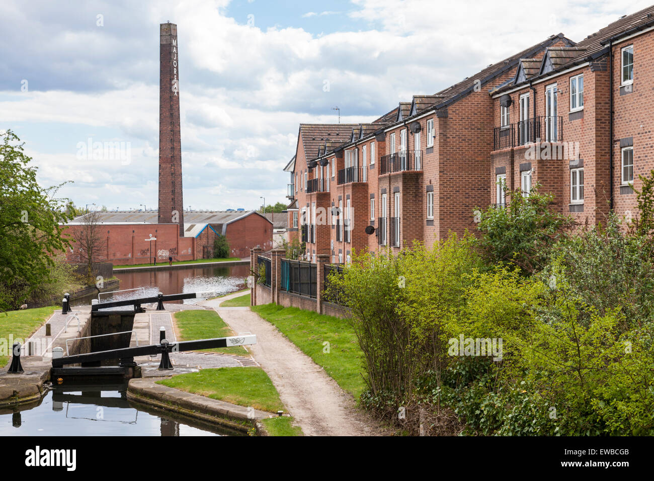 Residential housing on canalside of the Walsall Branch Canal as it joins the Walsall Canal, West Midlands, England, UK Stock Photo