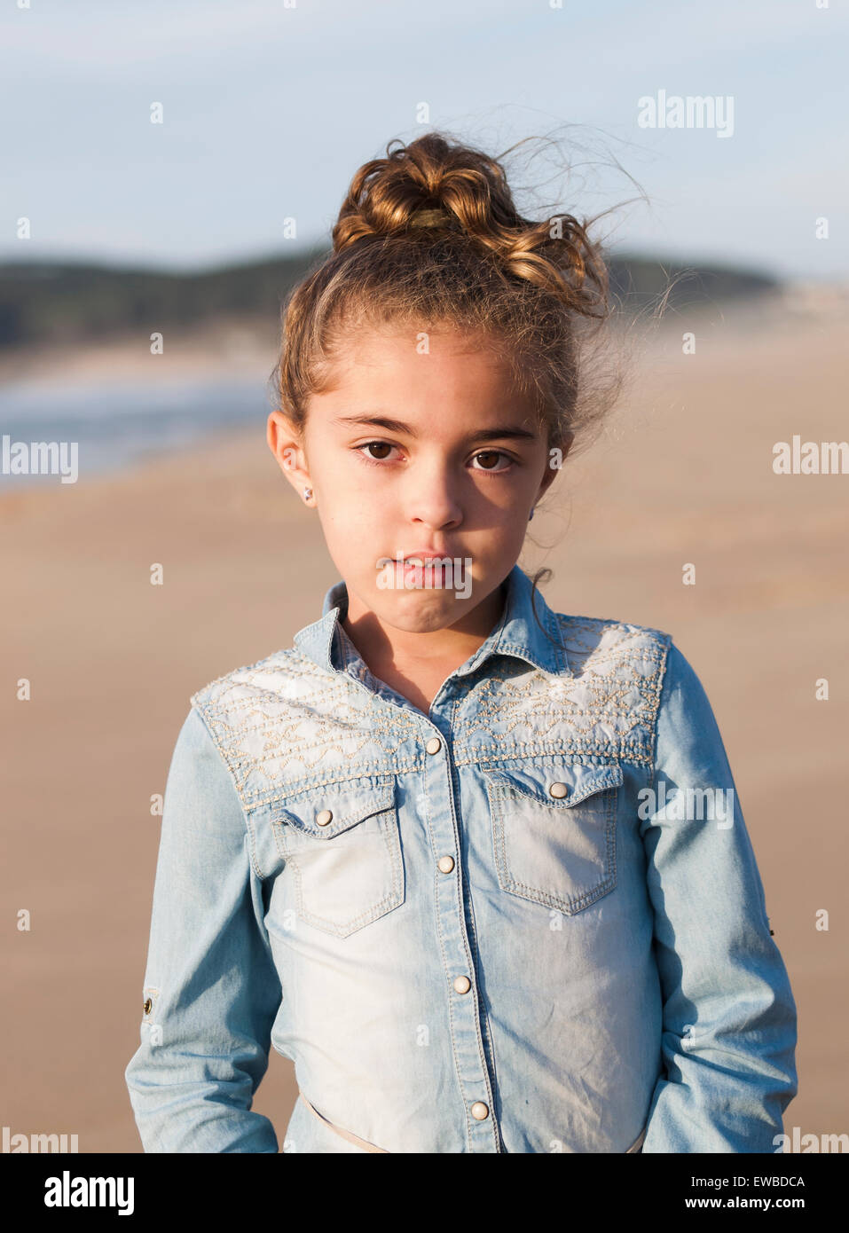 Spain, Galicia, Ferrol, Little girl portrait in the beach with sunset light Stock Photo