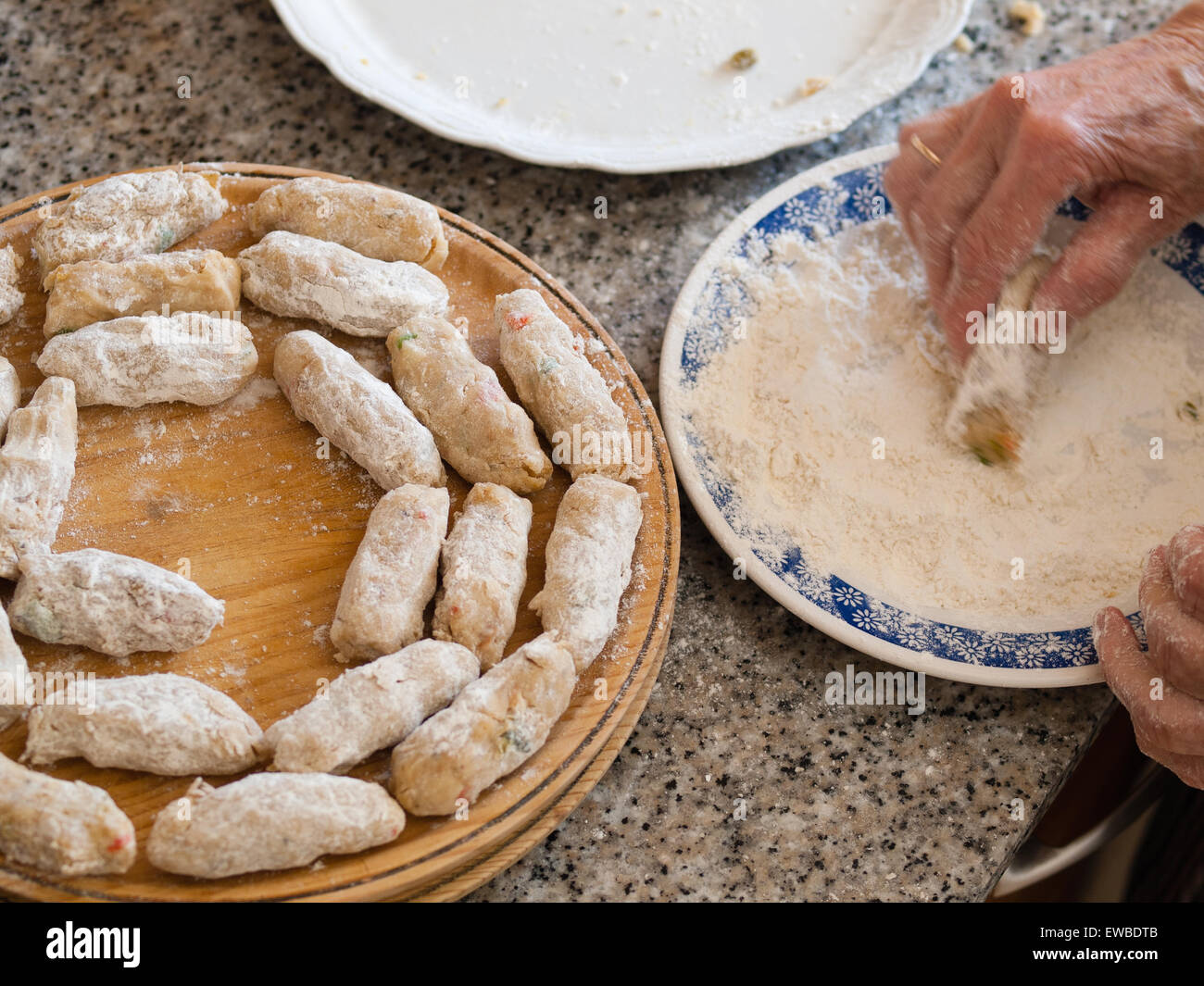 Preparing a homemade croquettes. The croquettes are being prepared by a grandmother. Stock Photo