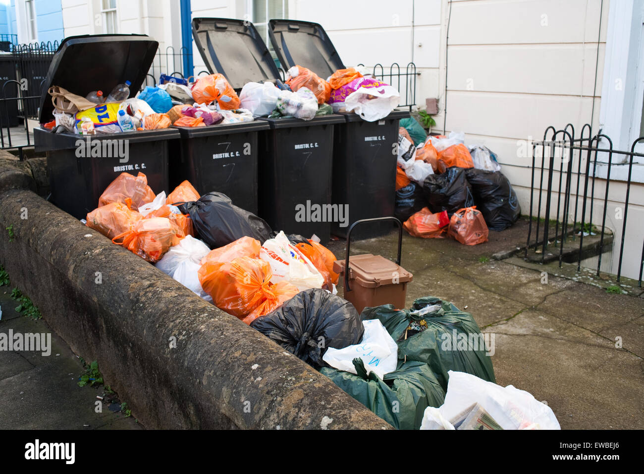 Rubbish piled up in bins outside houses Stock Photo Alamy