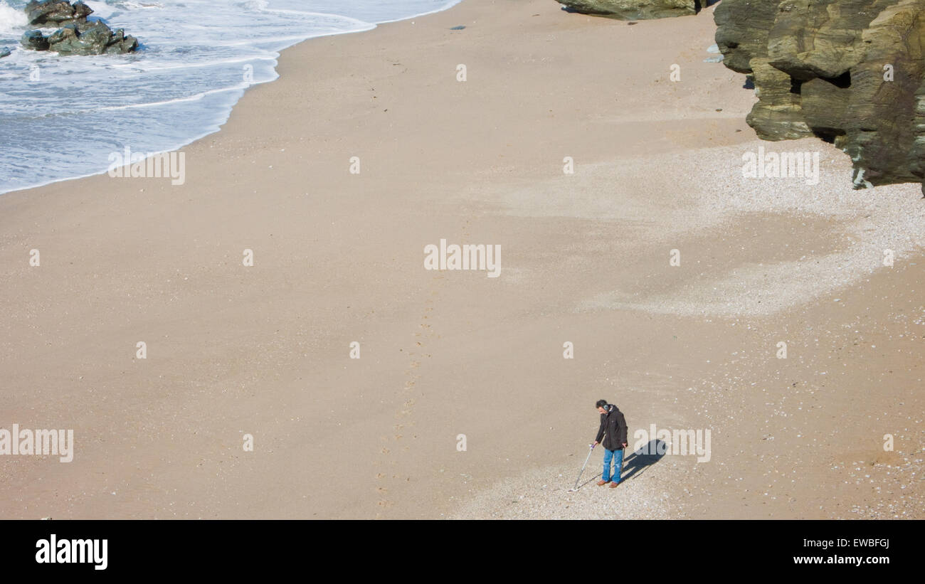 Man using metal detector on beach in Devon, UK Stock Photo Alamy