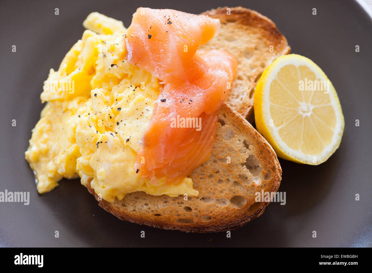 Smoked salmon and scrambled eggs on toast Stock Photo Alamy