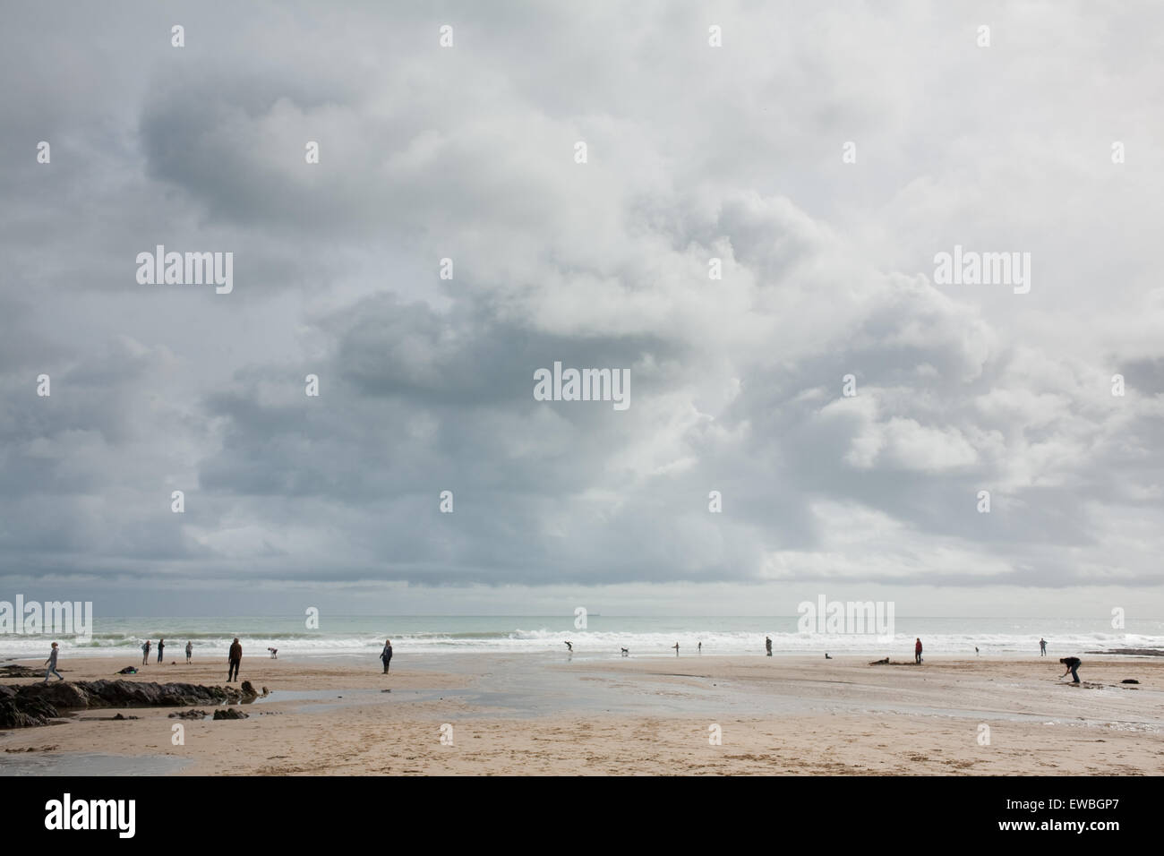 Wintry seaside scene with people walking on the beach in South Devon Stock Photo