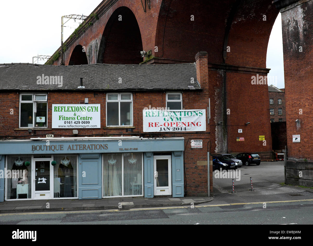 A boutique and upstairs gym underneath the viaduct in Stockport Stock Photo