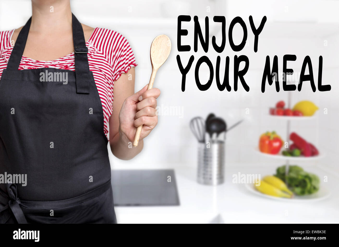 Enjoy your meal cook holds cooking spoon background. Stock Photo