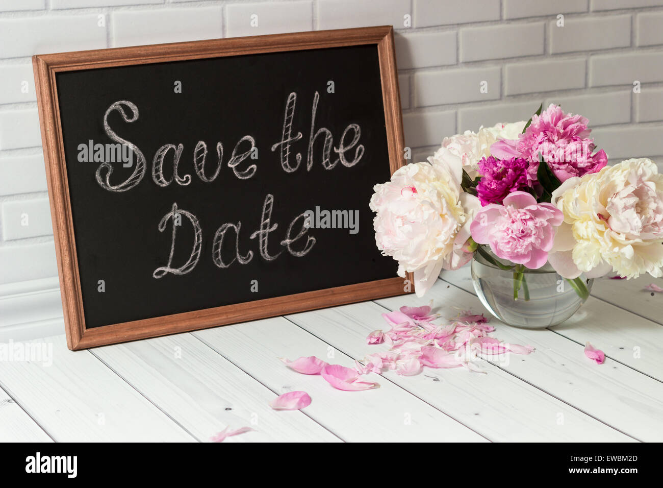 Invitation with bouquet of peonies and chalkboard Stock Photo