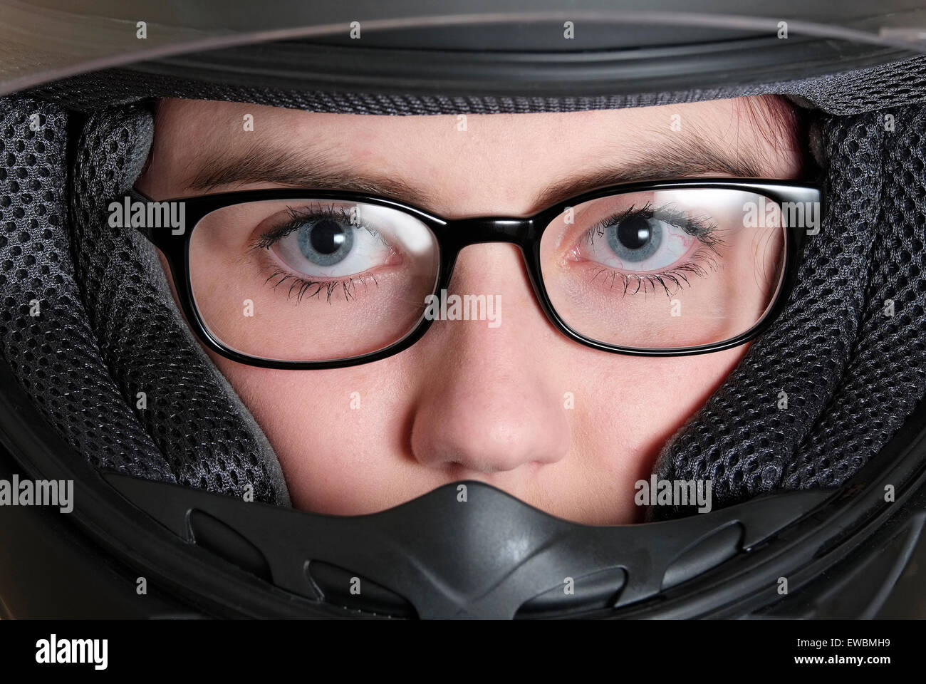 young female motorcyclist wearing black helmet Stock Photo