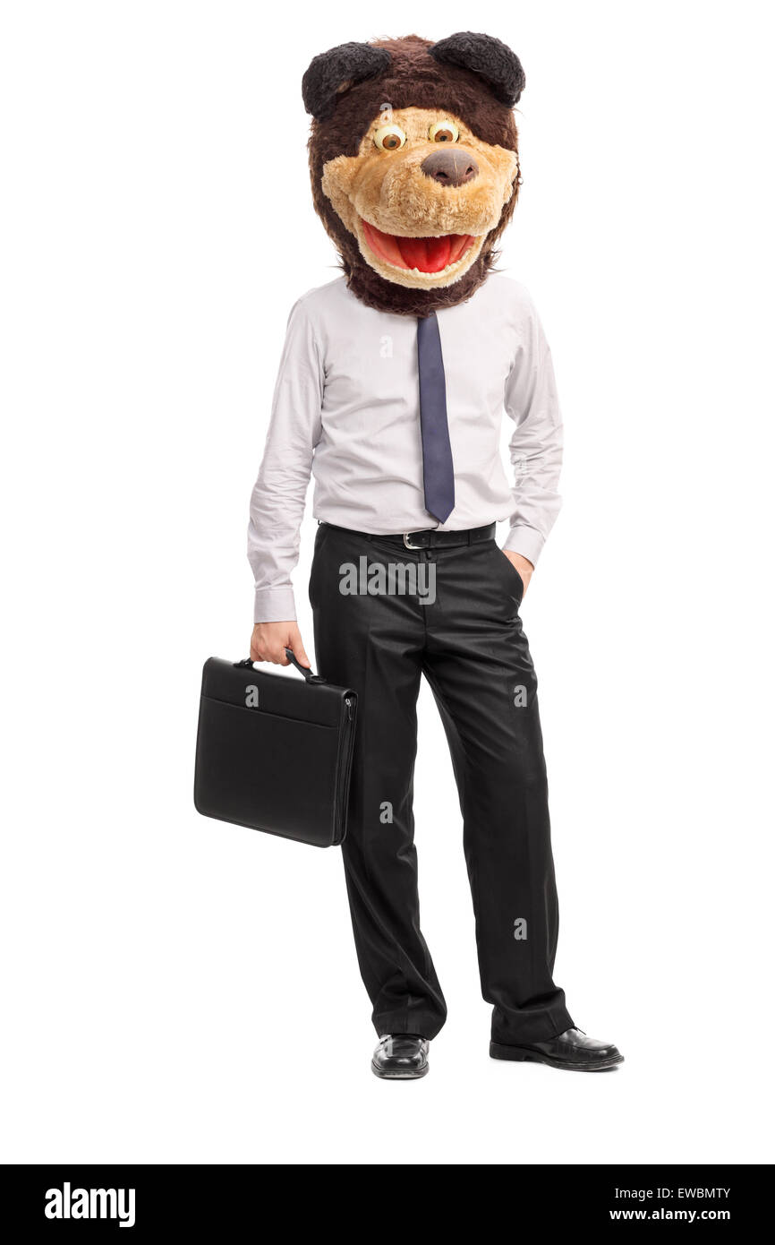 Full length portrait of a silly young businessman wearing a childish bear mask on his head and holding a suitcase Stock Photo