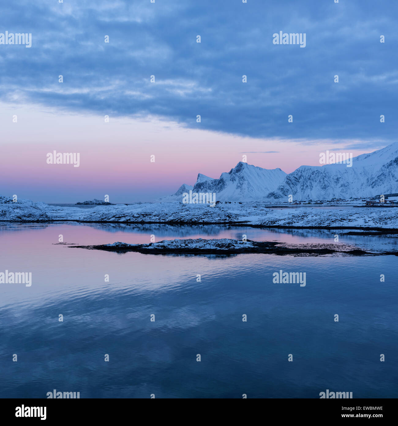 Winter twilight over mountain of Flakstadøy from Fredvang bridges, Lofoten Islands, Norway Stock Photo