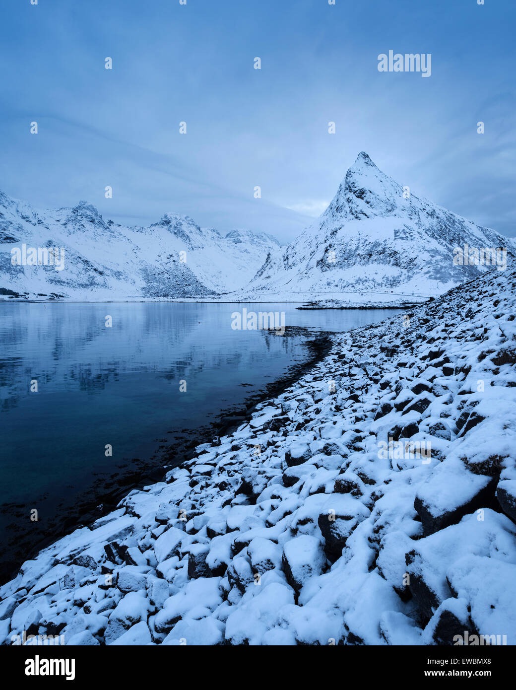 Volandstind mountain peak rises from sea near Fredvang bridges, Flakstadøy, Lofoten Islands, Norway Stock Photo