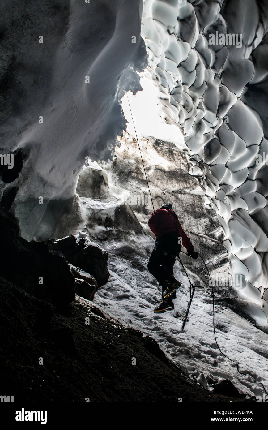 A scientist ascends a rope to exit a steam cave Stock Photo - Alamy