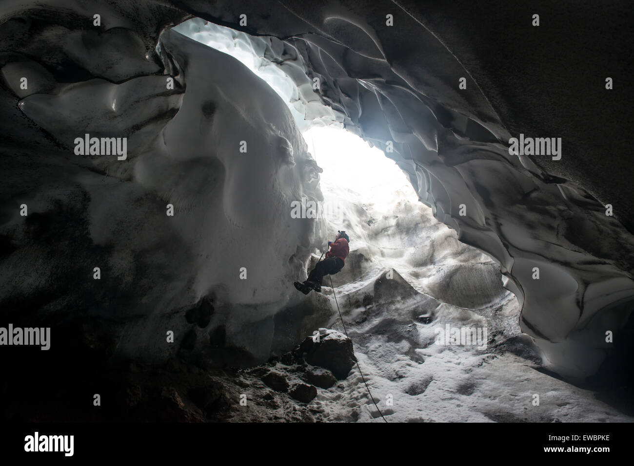 A scientist ascends a rope to exit a steam cave Stock Photo - Alamy