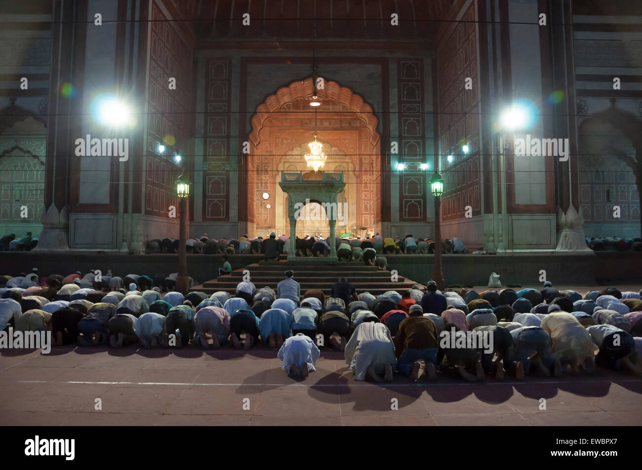 Men praying at Jama Masjid at night during Ramadan. Old Delhi, India. Stock Photo