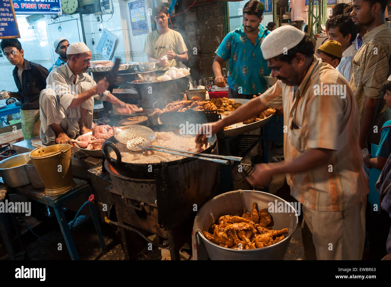 Men cooking in a local restaurant in Chandni Chowk, Old Delhi, India during Ramadan/ Ramzan. Stock Photo