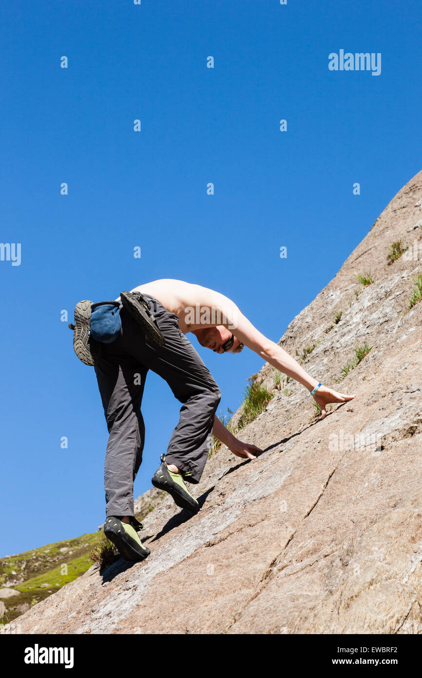 Rock climber climbing solo taking risks without a rope on Tennis Shoe (HS) climb on Idwal slabs in Snowdonia. Wales UK Britain Stock Photo