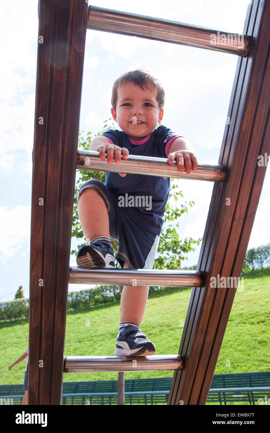 portrait of child climbing ropes in a playground Stock Photo