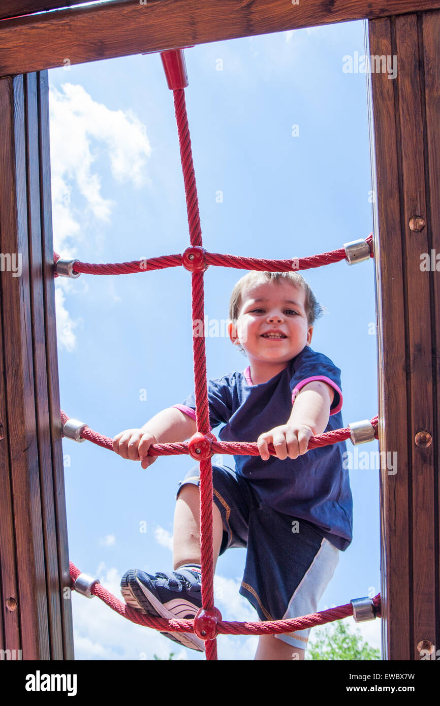 portrait of child climbing ropes in a playground Stock Photo Alamy