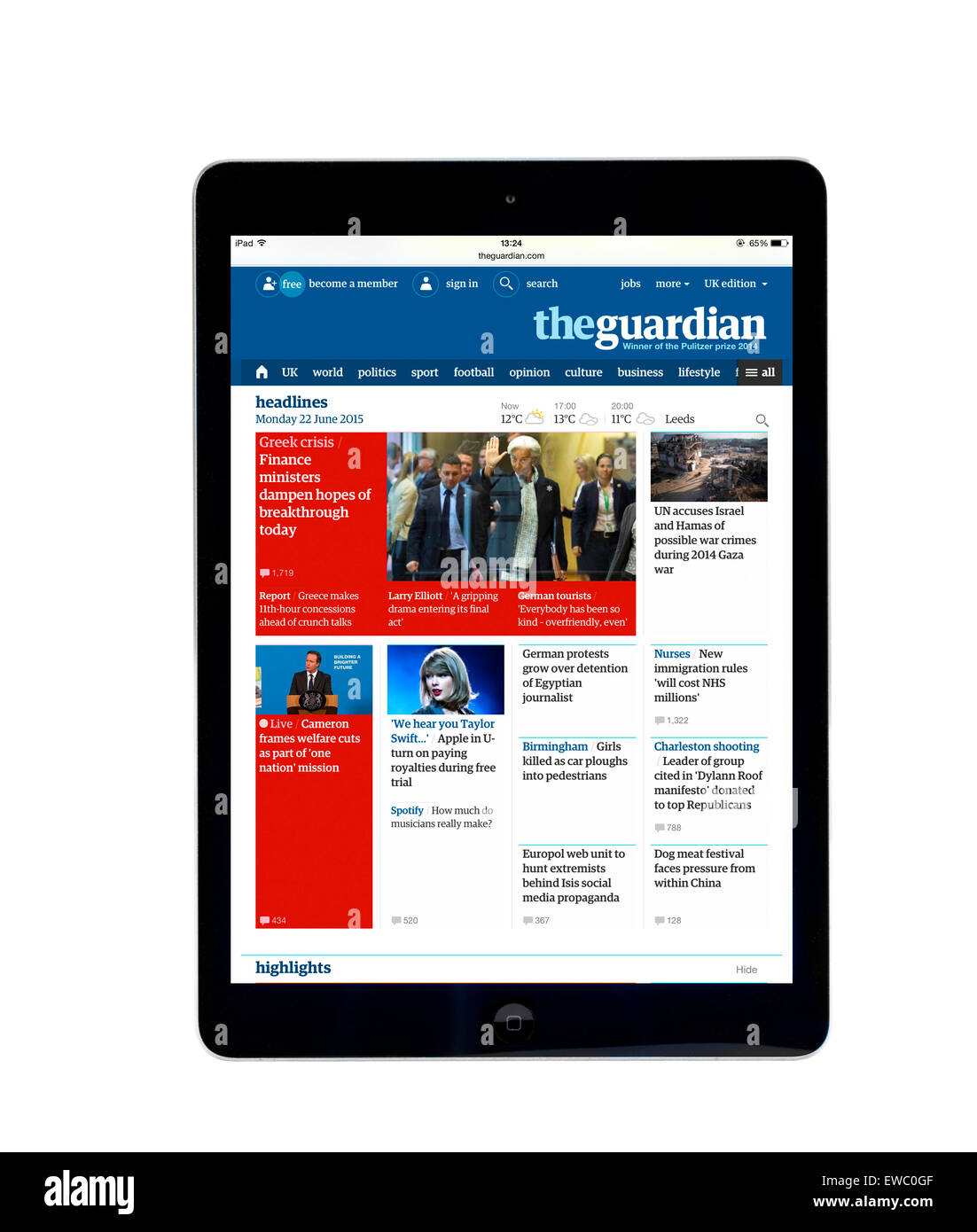Reading the internet edition of the Guardian online newspaper on an Apple iPad Air, UK Stock Photo