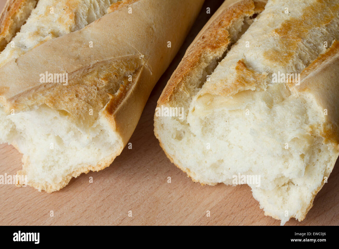 Crusty baguette on a wooden board Stock Photo
