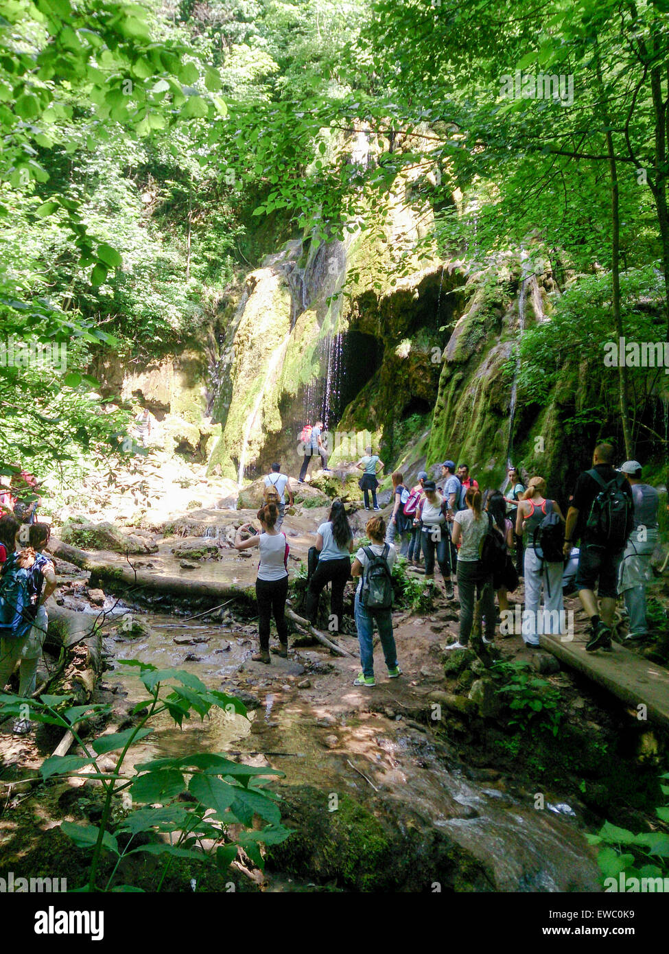 Cheile Nerei-Beusnita National Park, Romania - Jun 06, 2015. Group of people near beautiful waterfalls in a national park enjoyi Stock Photo