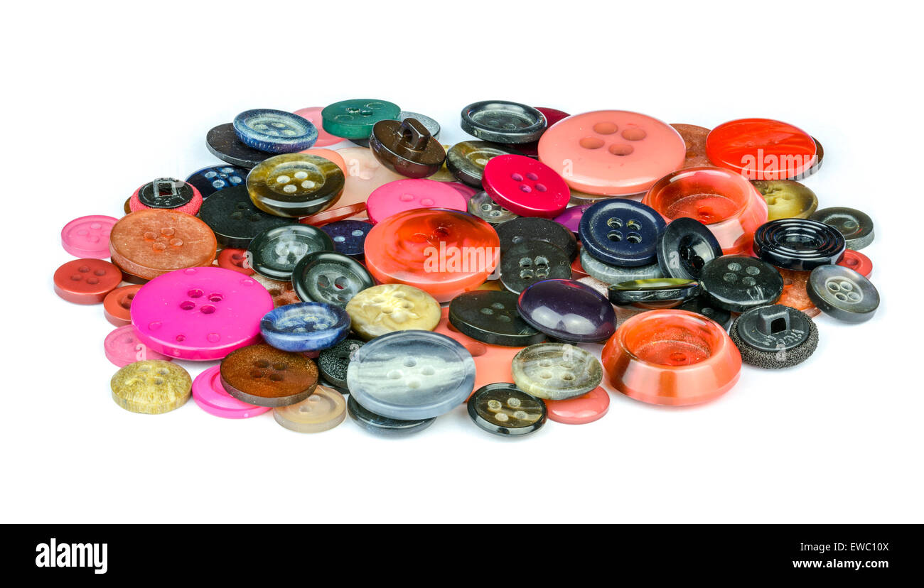 A pile of mixed sized multicoloured buttons on a white background. Stock Photo