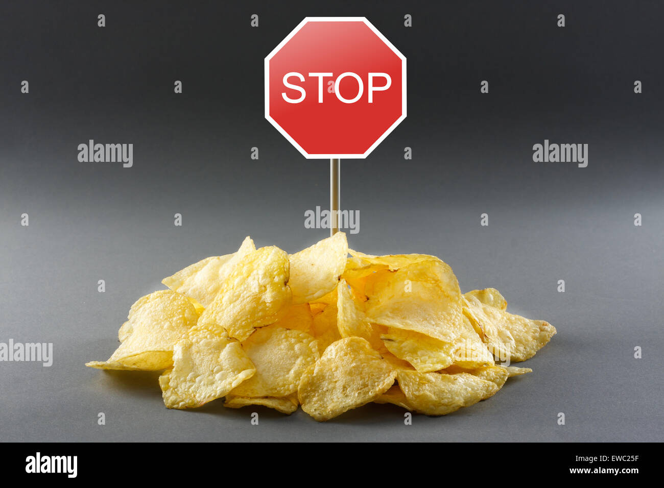Junk food concept - potato chips and road stop sign Stock Photo