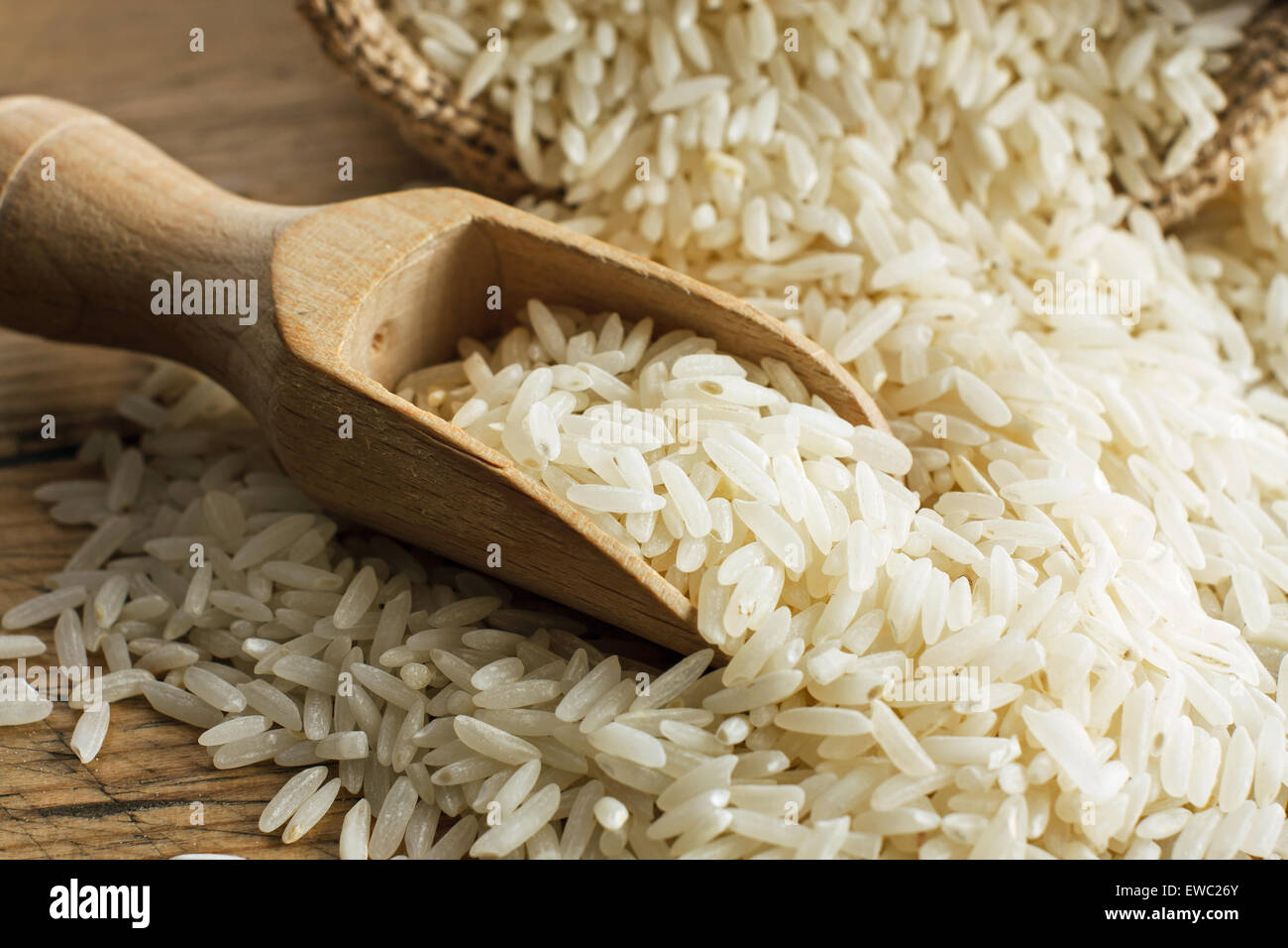 White long rice on wooden spoon Stock Photo