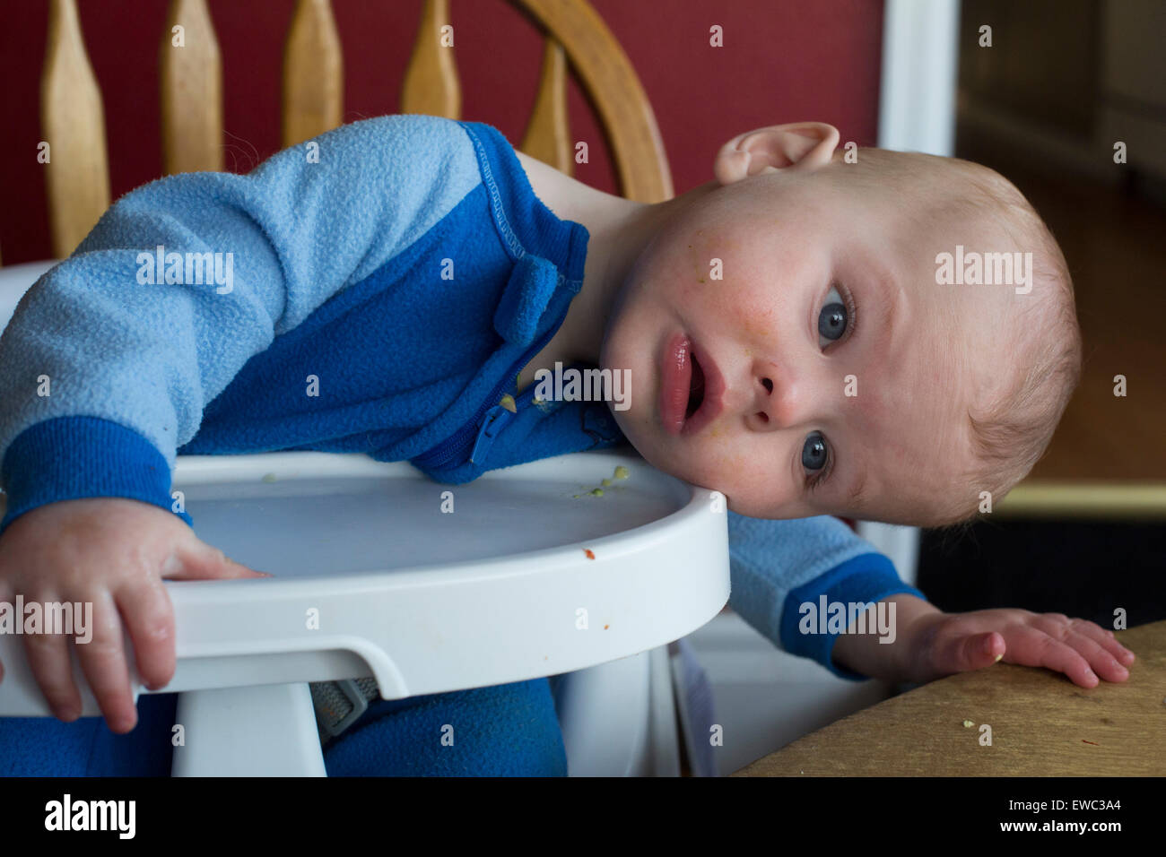 Wheat Ridge, Colorado - Ten-month-old Adam Hjermstad Jr.watches the world sideways from his high chair. Stock Photo