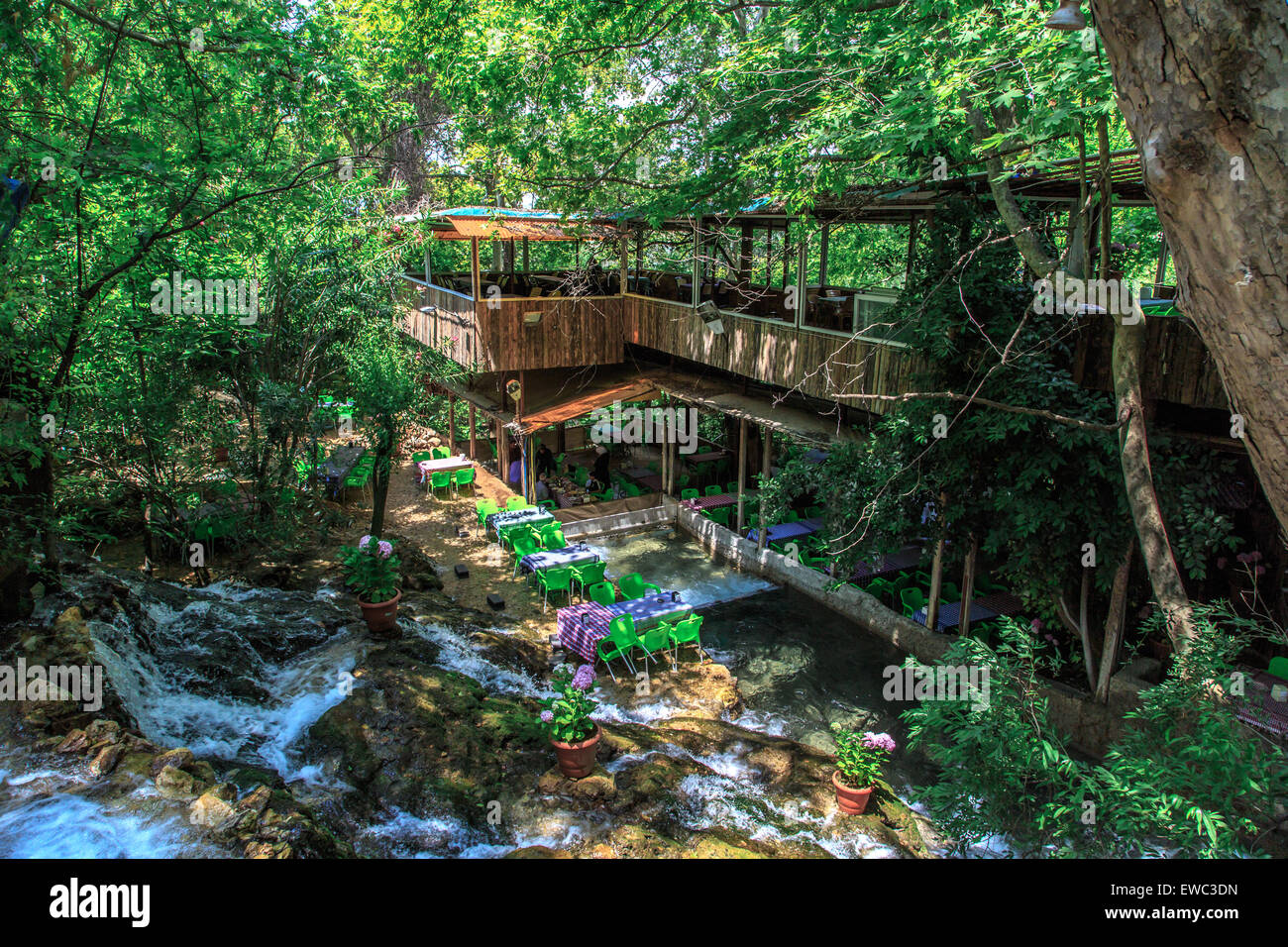 HATAY, TURKEY - JUNE 7, 2015 : Top view of restaurant with colourful table and chairs, settled in Harbiye Waterfall in Antakya. Stock Photo