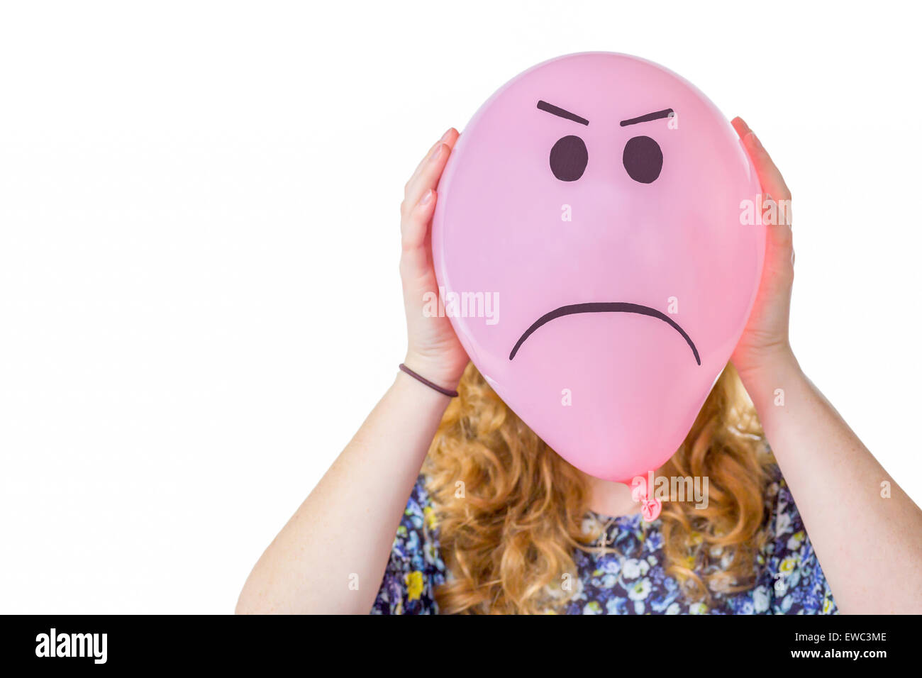 Pink balloon with frustrated expression in front  of girls face Stock Photo