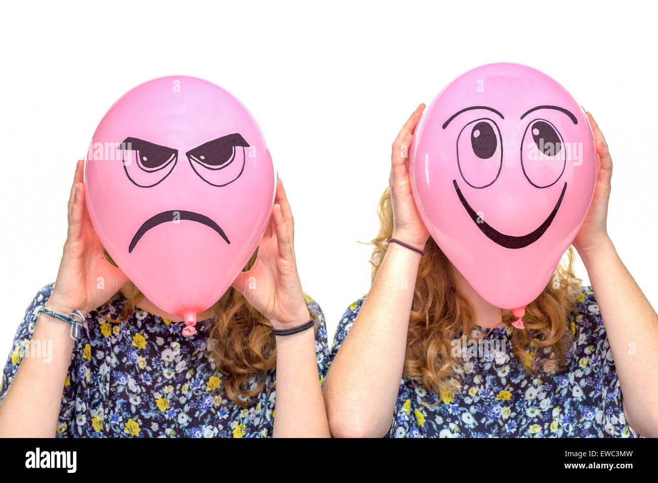 Two girls holding pink balloons with facial expressions of frustrated and smiling face isolated on white background Stock Photo