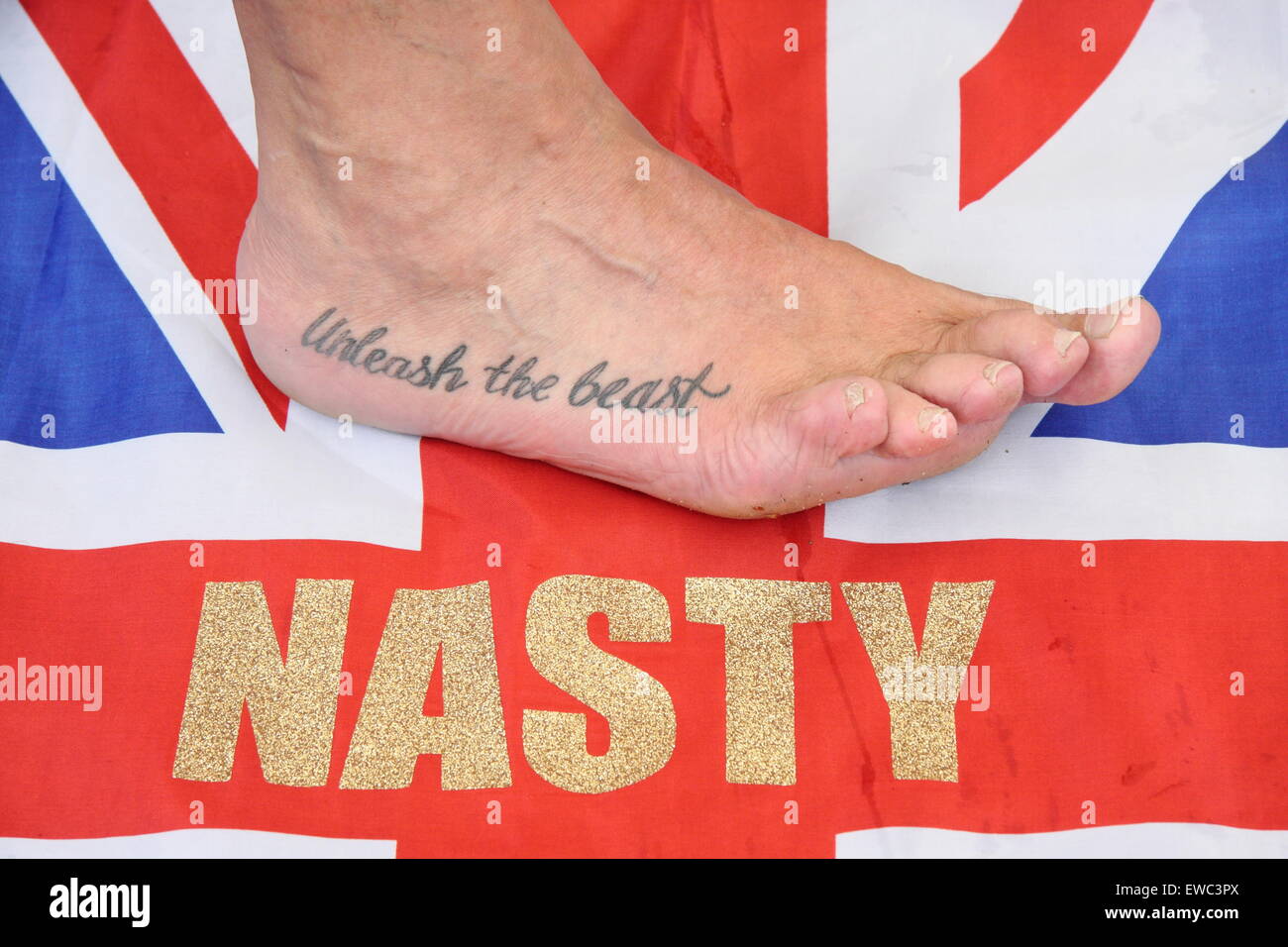 Veteran toe wrestling champion Alan 'Nasty' Nash displays a tattoo at the World Toe Wrestling Championships 2015 Derbyshire UK Stock Photo