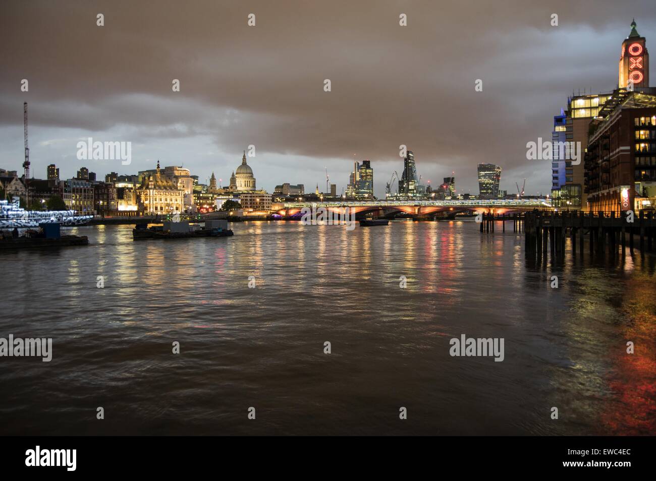 Skyline of London at night. View from south bank with lights reflecting in the thames Stock Photo